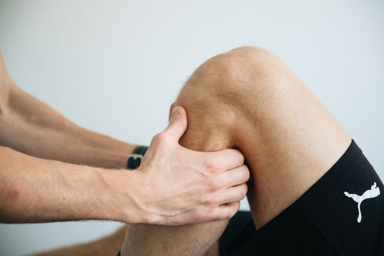 Services Detailed image of a physiotherapy session focusing on knee massage treatment.